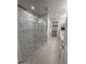 Modern bathroom showcasing a glass-enclosed shower with pebble flooring and marble tile walls at 5250 E Deer Valley Dr # 344, Phoenix, AZ 85054