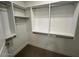 Walk-in closet featuring white shelving with metal rods for hanging clothes, and neutral carpeting at 5250 E Deer Valley Dr # 344, Phoenix, AZ 85054