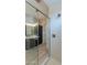 Bright bathroom featuring a glass shower with bronze showerhead, a dark vanity, and an open-door linen closet at 551 E Citrus Hollow Way, Queen Creek, AZ 85140