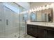 Modern bathroom featuring a glass-enclosed shower and dark wood vanity with a white countertop and undermount sink at 551 E Citrus Hollow Way, Queen Creek, AZ 85140