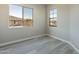 Bright bedroom with wood-look flooring, neutral walls and windows with neighborhood views at 551 E Citrus Hollow Way, Queen Creek, AZ 85140