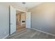 Bedroom with luxury vinyl floors, neutral walls, and view into room with fireplace at 551 E Citrus Hollow Way, Queen Creek, AZ 85140