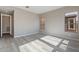 Bright bedroom with wood-look flooring, light walls and multiple windows offering neighborhood views at 551 E Citrus Hollow Way, Queen Creek, AZ 85140