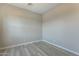 A serene bedroom with neutral walls and wood-look flooring offers a calming and inviting atmosphere at 551 E Citrus Hollow Way, Queen Creek, AZ 85140