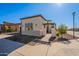 Angle of a home showing the front walkway, landscaping, and architectural detail at 551 E Citrus Hollow Way, Queen Creek, AZ 85140