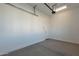 A clean, empty garage with a white door, ready for parking and storage at 551 E Citrus Hollow Way, Queen Creek, AZ 85140