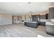 Open concept kitchen with stainless steel hood and grey cabinets at 551 E Citrus Hollow Way, Queen Creek, AZ 85140