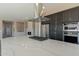 Kitchen island with white countertops, stainless steel appliances, and a modern hood at 551 E Citrus Hollow Way, Queen Creek, AZ 85140