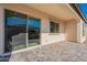 Cozy outdoor patio showcasing a covered area with a sliding glass door and window, perfect for enjoying the backyard at 551 E Citrus Hollow Way, Queen Creek, AZ 85140