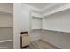 Spacious walk-in closet offering ample storage with shelving, hanging rods and added drawer beneath the shelves at 551 E Citrus Hollow Way, Queen Creek, AZ 85140