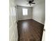 Cozy bedroom featuring wood-look tile flooring, a ceiling fan, and a window providing natural light at 5729 N 64Th Dr, Glendale, AZ 85301