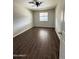 Inviting bedroom featuring wood-look tile flooring, a ceiling fan, and a window providing natural light at 5729 N 64Th Dr, Glendale, AZ 85301