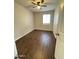 Cozy bedroom featuring wood-look tile flooring, a ceiling fan, and a window providing natural light at 5729 N 64Th Dr, Glendale, AZ 85301