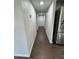 Hallway featuring wood-look tile floors and bright lighting leading to other areas of the home at 5729 N 64Th Dr, Glendale, AZ 85301