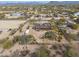 Aerial view of residence surrounded by desert landscaping and neighboring homes in a tranquil neighborhood at 5911 E Peak View E Rd, Cave Creek, AZ 85331