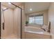 Bathroom featuring walk-in shower, soaking tub, and natural light at 5911 E Peak View E Rd, Cave Creek, AZ 85331