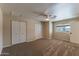 Bedroom featuring a large window, ceiling fan and mirrored closet doors at 5911 E Peak View E Rd, Cave Creek, AZ 85331