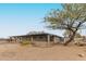 Exterior shot showing the screened-in porch, lush trees, and desert plants at 5911 E Peak View E Rd, Cave Creek, AZ 85331