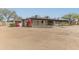 Expansive home exterior featuring desert landscaping, vibrant bougainvillea, and a charming covered porch at 5911 E Peak View E Rd, Cave Creek, AZ 85331