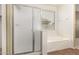 Bright bathroom featuring a glass shower and soaking tub under a window at 5948 W Leiber Pl, Glendale, AZ 85310