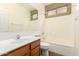 Bright bathroom featuring a single vanity, toilet and shower-tub combo at 5948 W Leiber Pl, Glendale, AZ 85310