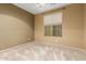 Cozy bedroom with neutral walls, a ceiling fan, and a bright window at 5948 W Leiber Pl, Glendale, AZ 85310