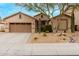 Charming single-Gathering home showcasing desert landscaping with cacti, gravel, and a mature tree at 5948 W Leiber Pl, Glendale, AZ 85310