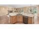 Kitchen featuring a dishwasher, stone backsplash, granite countertops, and stainless sink at 5948 W Leiber Pl, Glendale, AZ 85310