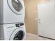 Laundry area featuring a stacked washer and dryer next to the door at 5948 W Leiber Pl, Glendale, AZ 85310