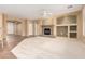 Open-concept living room boasts a stone fireplace, neutral carpet, and large arched doorways at 5948 W Leiber Pl, Glendale, AZ 85310