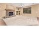 Spacious living room featuring a stone fireplace, built-in shelves, and a large window at 5948 W Leiber Pl, Glendale, AZ 85310