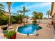 Backyard swimming pool surrounded by lush landscaping and rock features at 5948 W Leiber Pl, Glendale, AZ 85310