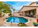 Beautiful backyard pool with rock accents surrounded by desert landscaping and a patio area at 5948 W Leiber Pl, Glendale, AZ 85310