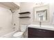 Bright bathroom with shower-tub combo, floating shelves, and sleek vanity at 6427 E Grandview Dr, Scottsdale, AZ 85254