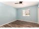 Bedroom featuring modern ceiling fan, wood-look floors and light blue walls at 6427 E Grandview Dr, Scottsdale, AZ 85254