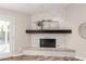 Modern fireplace featuring stylish white-brick surround, floating mantle, and decorative art at 6427 E Grandview Dr, Scottsdale, AZ 85254