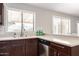 Well-lit kitchen showcasing neutral countertops, updated fixtures, and stainless steel dishwasher at 6427 E Grandview Dr, Scottsdale, AZ 85254