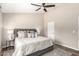 Bright main bedroom with neutral palette, ceiling fan, and bedside tables with lamps at 6427 E Grandview Dr, Scottsdale, AZ 85254