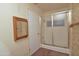 Bathroom featuring a glass shower and an ornate, wooden-framed mirror at 655 W Mission Dr, Chandler, AZ 85225