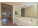 Bright bathroom features double sinks, a large mirror, and a doorway to another room at 655 W Mission Dr, Chandler, AZ 85225