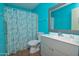 Bathroom with blue walls, a shower with curtain, and a single sink vanity at 655 W Mission Dr, Chandler, AZ 85225