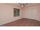 Bedroom with wood flooring, a window for natural light, and a closet at 655 W Mission Dr, Chandler, AZ 85225