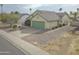 Inviting single-level home featuring desert landscaping, a green garage door, and an expansive driveway at 655 W Mission Dr, Chandler, AZ 85225