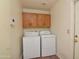 Functional laundry room with cabinets, a washer, and a dryer for convenient chores at 655 W Mission Dr, Chandler, AZ 85225