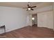 Living room with hardwood floors, ceiling fan, and view to the bathroom and a large open space at 655 W Mission Dr, Chandler, AZ 85225