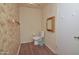 Cozy powder room with hardwood floors and decorative wallpaper at 655 W Mission Dr, Chandler, AZ 85225