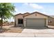 Charming single-story home features a well-manicured yard and attached two-car garage at 7147 S Morning Dew Ln, Buckeye, AZ 85326