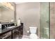 Bathroom with a black granite countertop and modern fixtures and a glass door shower at 7428 N Via Camello Del Norte -- # 182, Scottsdale, AZ 85258