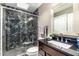 Bathroom featuring black granite shower walls and a pebble floor in the standing shower at 7428 N Via Camello Del Norte -- # 182, Scottsdale, AZ 85258