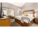 Bedroom featuring a large bed and mirrored closet doors and a view into another room at 7428 N Via Camello Del Norte -- # 182, Scottsdale, AZ 85258